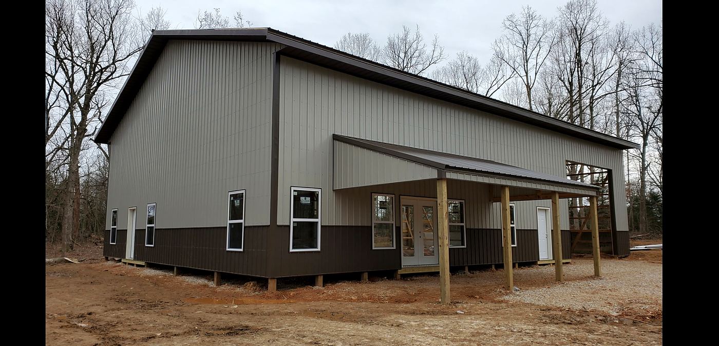 Completed barndominium exterior with covered front porch