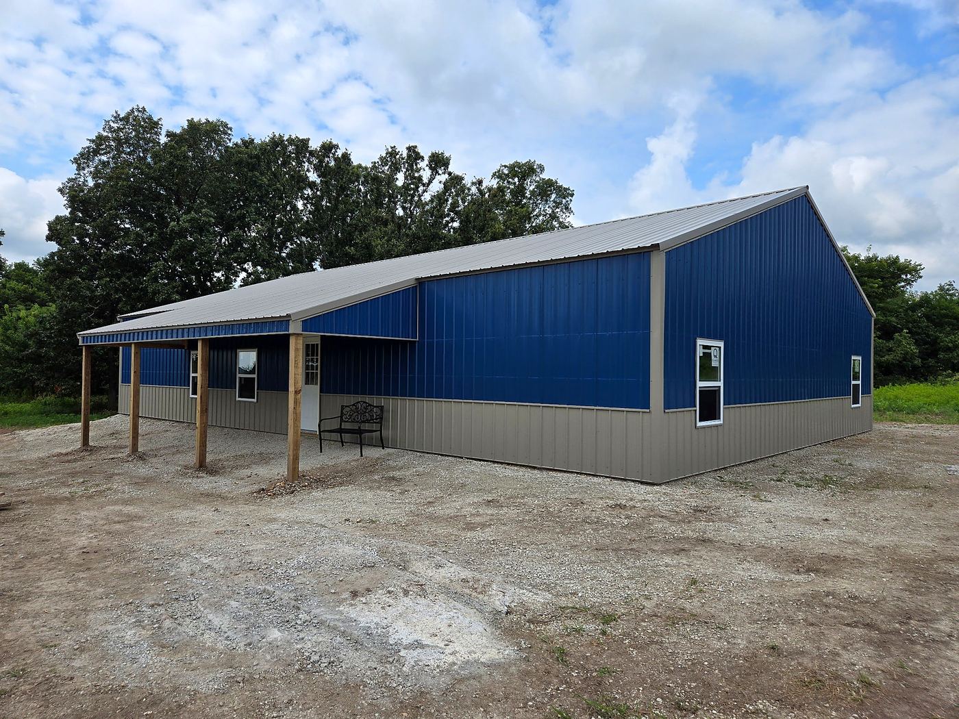 Blue barndominium exterior with long covered porch
