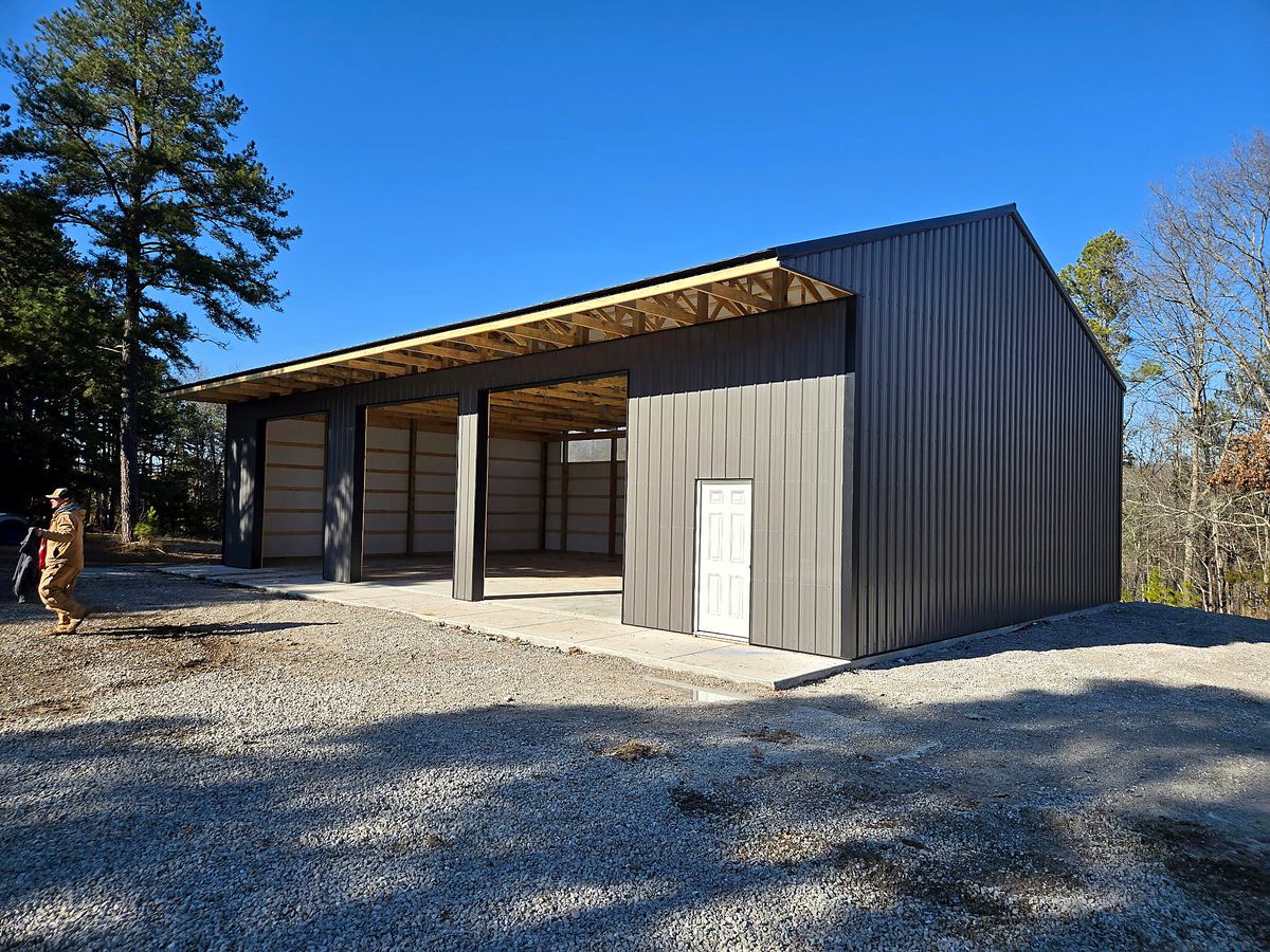Finished gray pole barn with open bays
